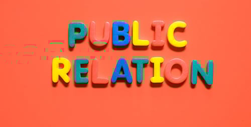 Hands spell Public Relation with colorful letters