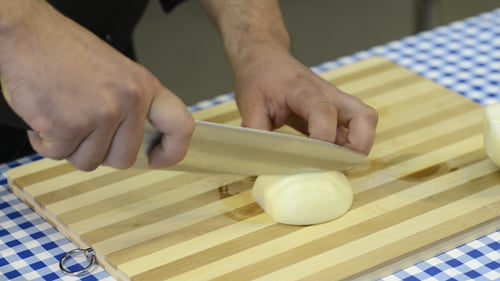 Chef Dices White Onion on Cutting Board