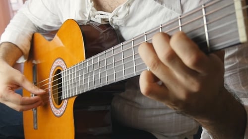 Man Playing Acoustic Classical Guitar in Home