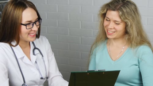 Doctor Consults with Patient in Hospital Office