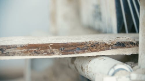 Machine Processing Wooden Plank at Industrial Workplace