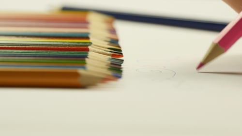 Drawing with Pink Pencil Beside Colorful Pencils