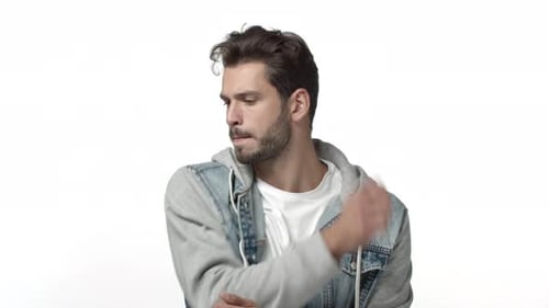 Young Man Gesturing with Hands in Studio Setting
