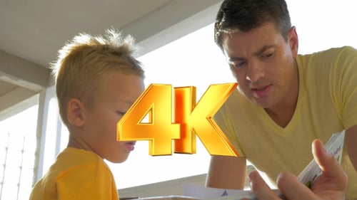 Dad Reads Book with His Son