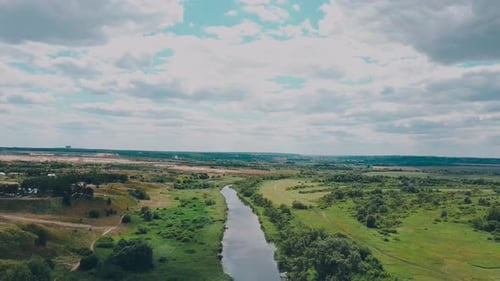 the River Goes Into the Distance Surrounded By Green Trees on a Clear Day