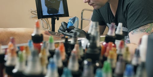 Tattoo Artist at Work in Tattoo Studio
