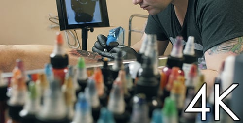 Adult Tattoo Artist Giving Tattoo in Bright Studio