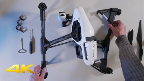 Disassembling Drone Parts on White Surface