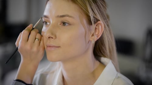 Woman Having Eyebrows Styled with Makeup Brush