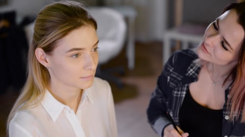 Woman Getting Makeup Applied by Makeup Artist