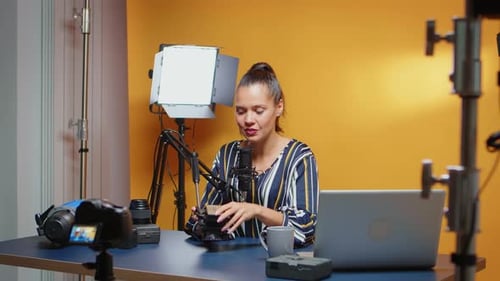 Woman Talking About Camera Equipment in Studio