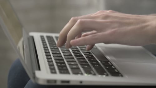 Close Up of Hands Typing on Laptop