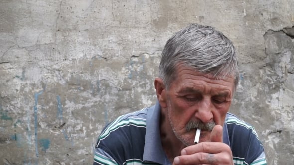 old person smoking cigarette Senior Man Lighting and Smoking a Cigarette Outdoors old person smoking cigarette Senior Man Lighting and Smoking a Cigarette Outdoors