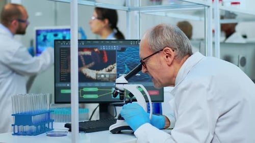 Senior Scientist Using Microscope in Bright Laboratory