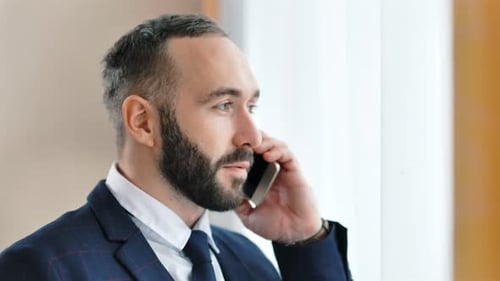 Closeup Portrait of Attractive Smiling Male Businessman Talking Using Smartphone