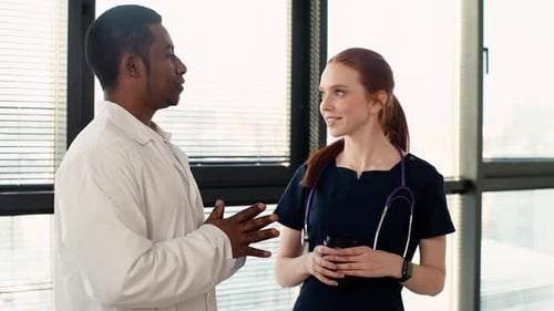 Medical Professionals Discussing Work in Modern Office