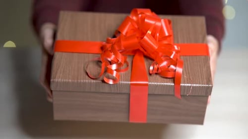 Presenting a Gift Box with Red Ribbon