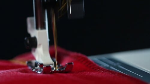Sewing Machine Stitching Red Fabric Close-Up
