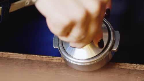 Tamping Coffee Grounds in Portafilter Close Up