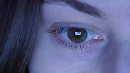 Girl's Eye Reading Internet, With Reflection Of Screen In Her Eye At Night