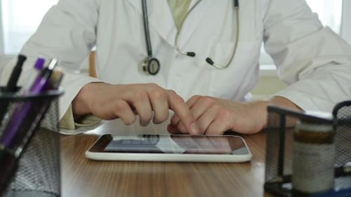 Doctor Working On Tablet Pc