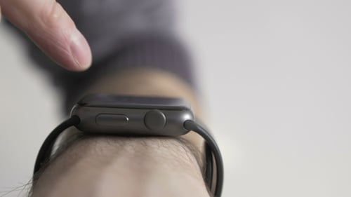 Finger Interacting with Black Smart Watch