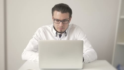 Handsome Young Man In Shirt Working On Laptop While Sitting At His Working Place