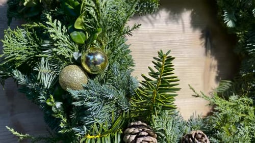 Christmas Wreath With Hanging christmas balls On wooden Front Door.Close up shot.