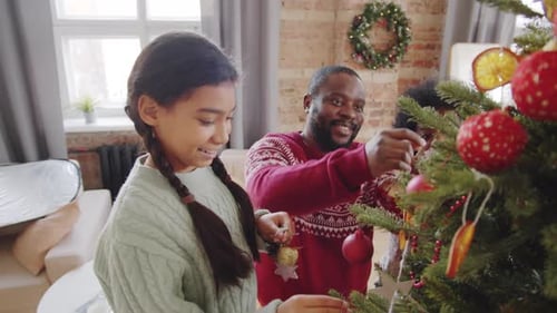 Happy Family Decorating Christmas Tree Together