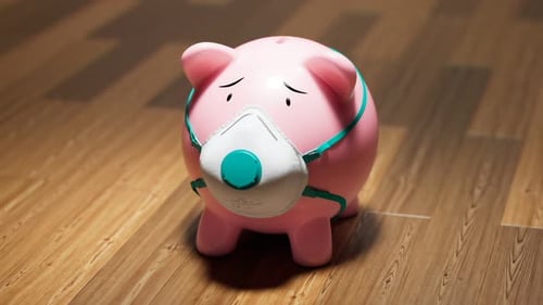 Piggy bank in a protective mask. Health and financial issues while the epidemic.