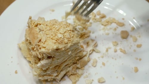 Cake Piece Being Cut on Plate