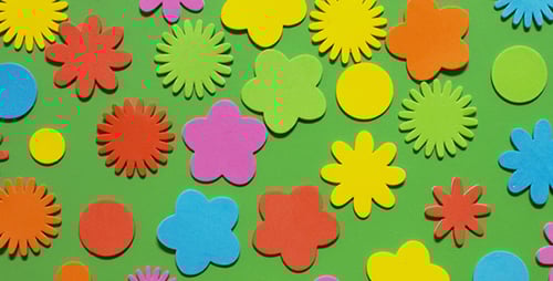 Colorful Flower Shapes Arranged on Green Background