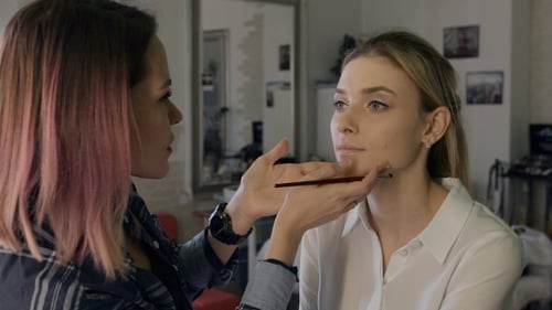 Makeup Artist Applying Makeup to a Blonde Woman