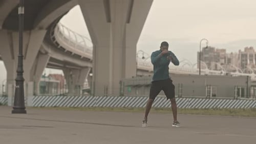 Young Man Warming Up to Box Outdoors