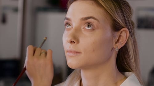 Woman Getting Eye Makeup Applied with Brush