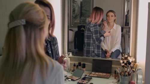 Makeup Artist Applying Lipstick in Fashion Studio