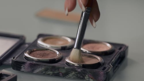 Stylist Gaining Cosmetic Shadows On The Brush.