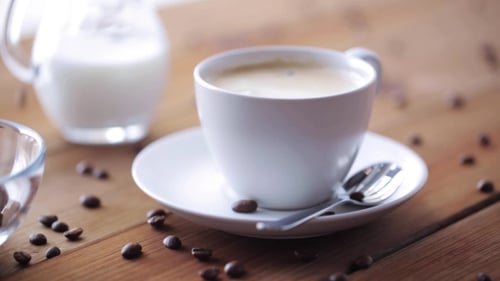 Close up of a Coffee Cup and Coffee Beans