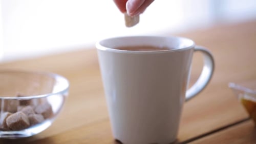 Hand Adding Sugar To Cup Of Tea Or Coffee 25