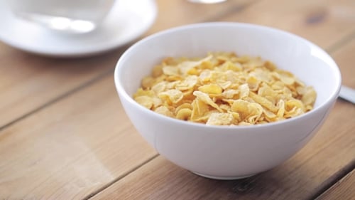Milk Being Poured On Corn Flakes for Breakfast