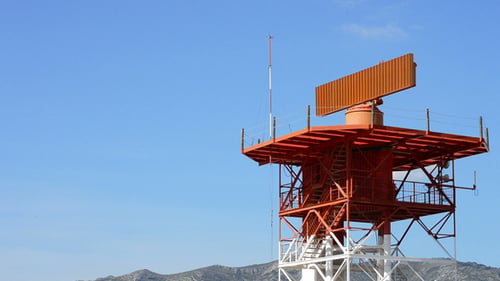 Rotating Radar Tower on Clear Day