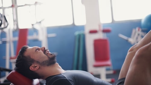 Man Doing Leg Press Exercise in Gym