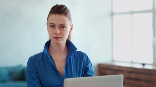 Attractive Business Woman in Office, Smiling, Looking at Laptop Camera Online