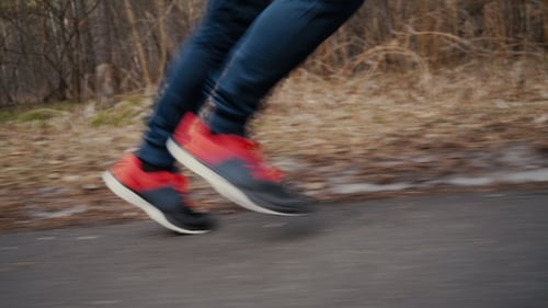 Man Runs on Path in Forest