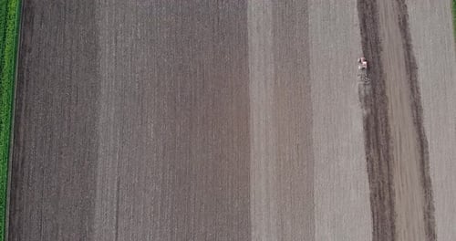 Aerial View of Tractor Tilling Soil in Field