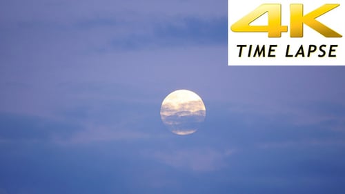 Majestic Moon Ascends in a Cloudy Night Sky