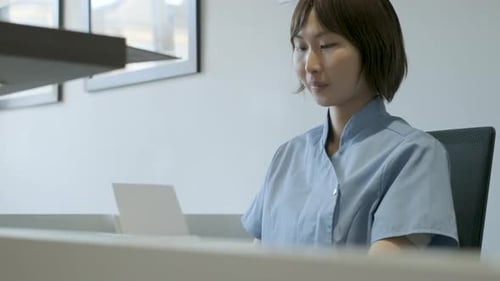 Woman Working at Desk in Modern Office