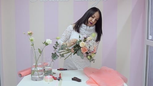Woman Creates Floral Bouquet at Florist Workplace
