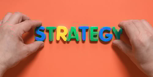 Hands Spell Strategy with Bright Colorful Letters