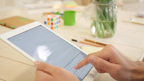Typing on Tablet Device at Bright Desk